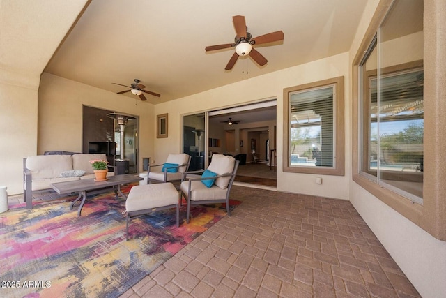 view of patio with outdoor lounge area and ceiling fan