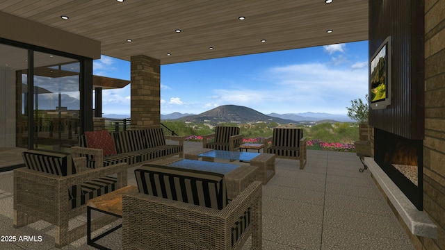 view of patio featuring an outdoor living space and a mountain view