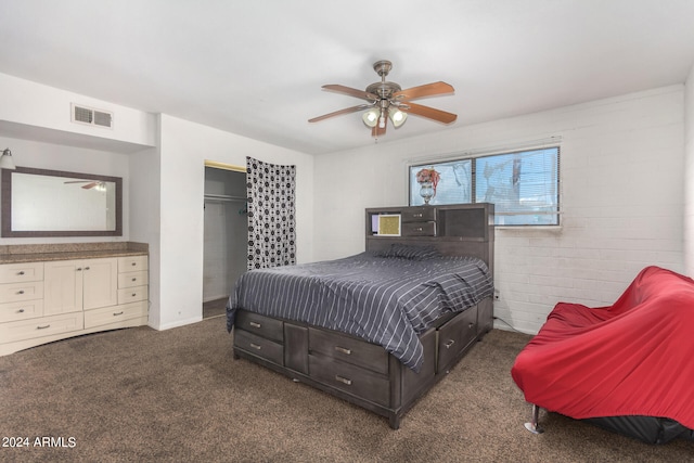 carpeted bedroom with brick wall, ceiling fan, and a closet