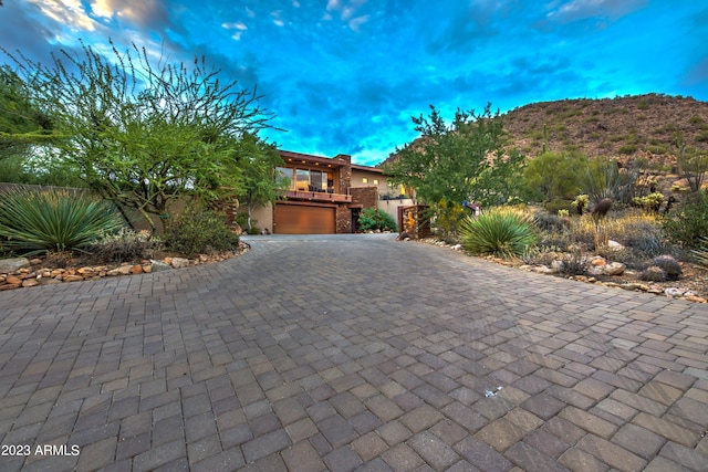 view of front of home with a mountain view and a garage