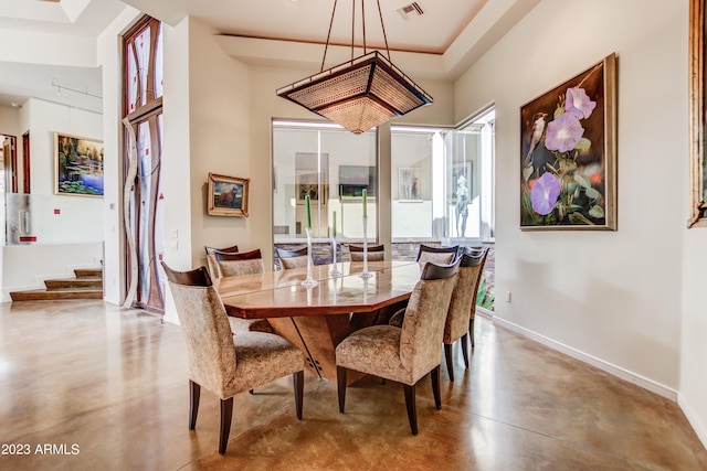 dining space featuring a raised ceiling