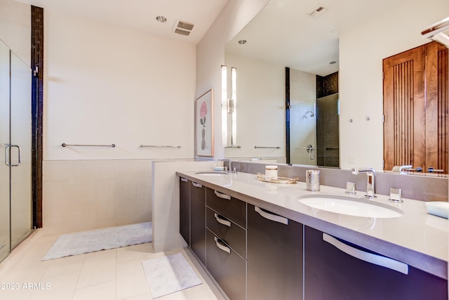 bathroom with double sink, tile flooring, large vanity, and an enclosed shower