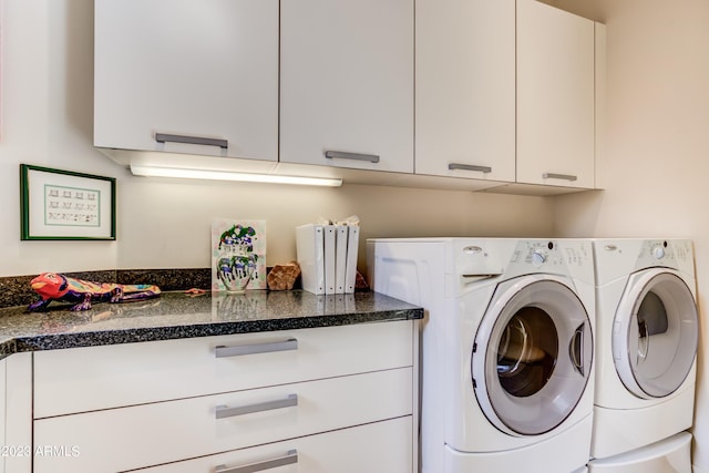 washroom featuring cabinets and washing machine and dryer