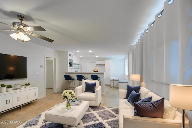 living room with ceiling fan and light wood-type flooring