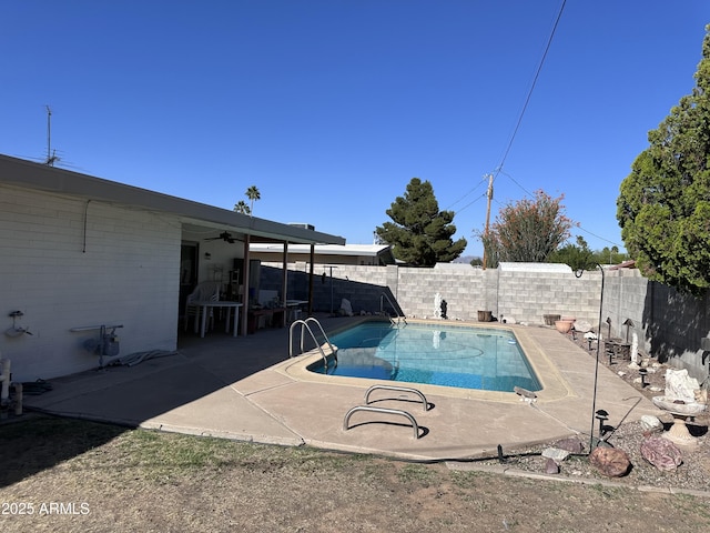 view of pool featuring a fenced backyard, ceiling fan, and a patio