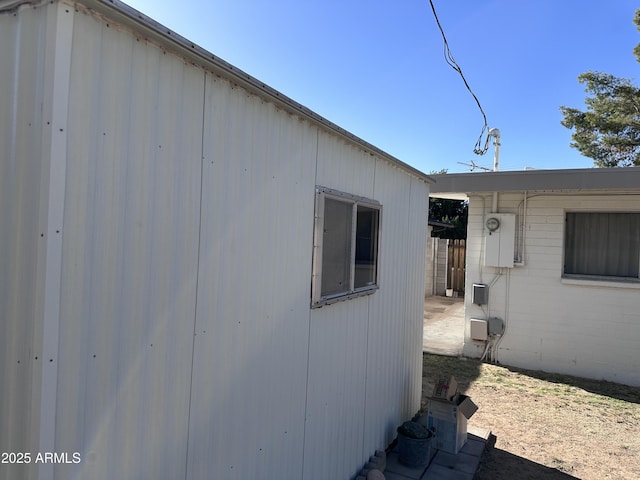 view of side of property with an outbuilding and fence