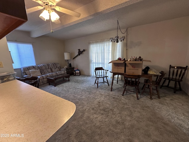 carpeted living area featuring a textured ceiling and ceiling fan