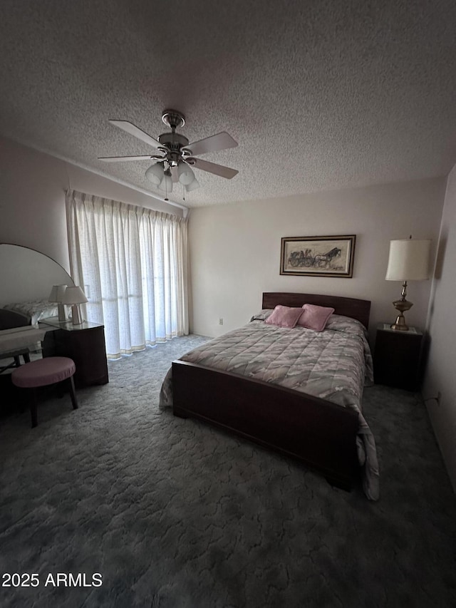 carpeted bedroom featuring a textured ceiling and ceiling fan