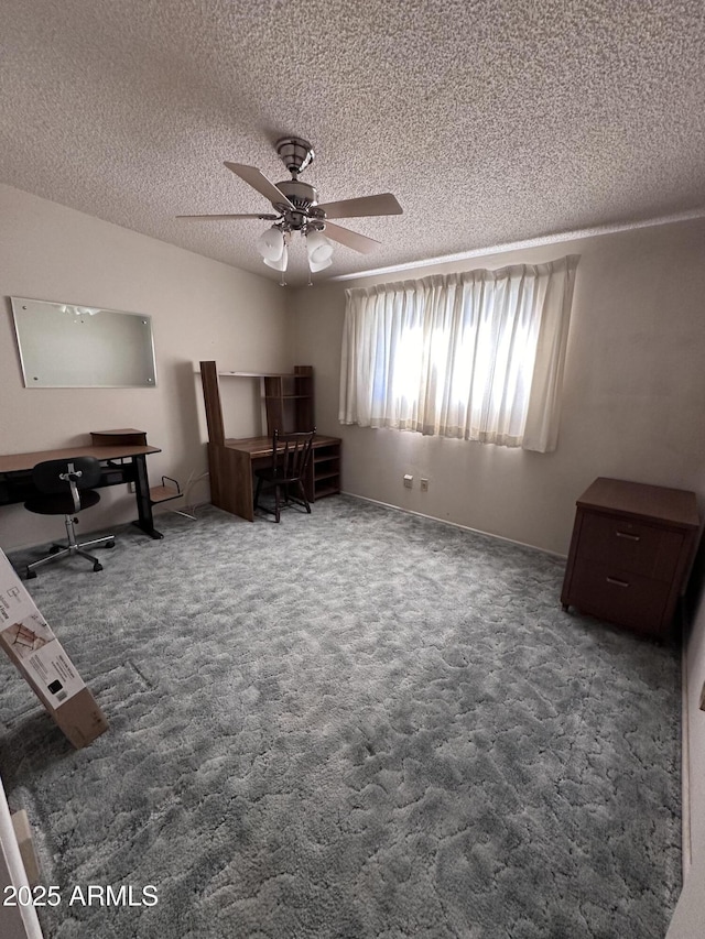 home office featuring a ceiling fan, a textured ceiling, and carpet floors