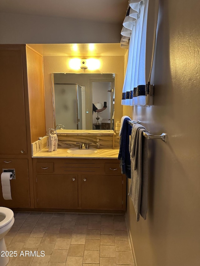 full bathroom featuring vanity, a stall shower, toilet, and tile patterned flooring
