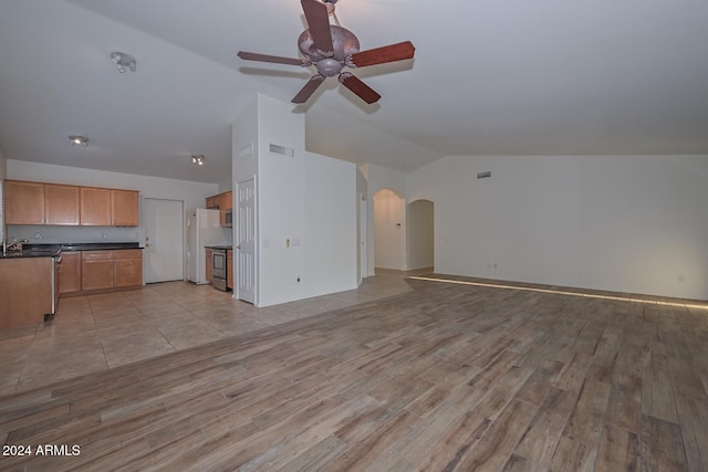 unfurnished living room featuring light hardwood / wood-style floors, vaulted ceiling, ceiling fan, and sink