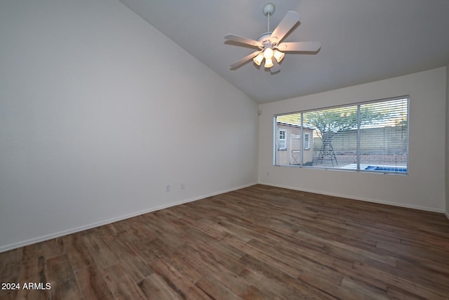 unfurnished room with vaulted ceiling, ceiling fan, and dark wood-type flooring