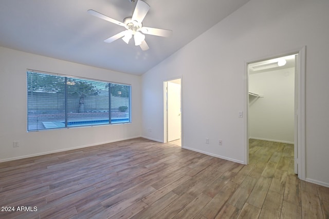 unfurnished room with light wood-type flooring, ceiling fan, and lofted ceiling