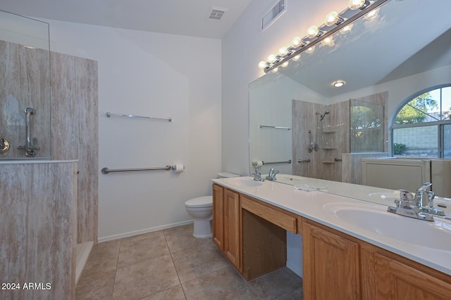 bathroom featuring vanity, a shower, tile patterned floors, vaulted ceiling, and toilet