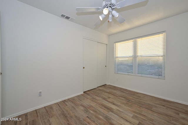 empty room with ceiling fan and hardwood / wood-style floors