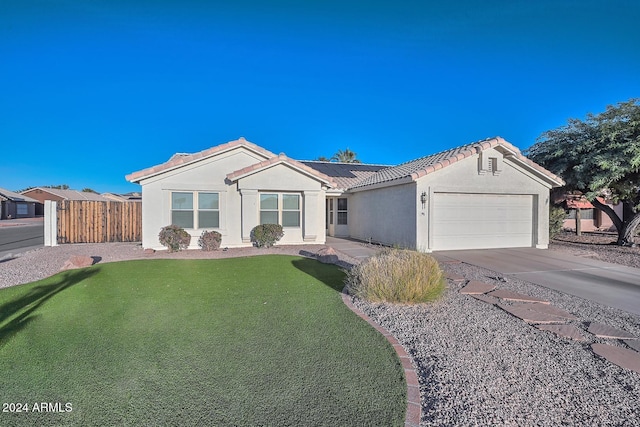 ranch-style home with solar panels, a garage, and a front lawn