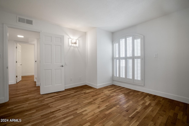 empty room featuring dark hardwood / wood-style flooring