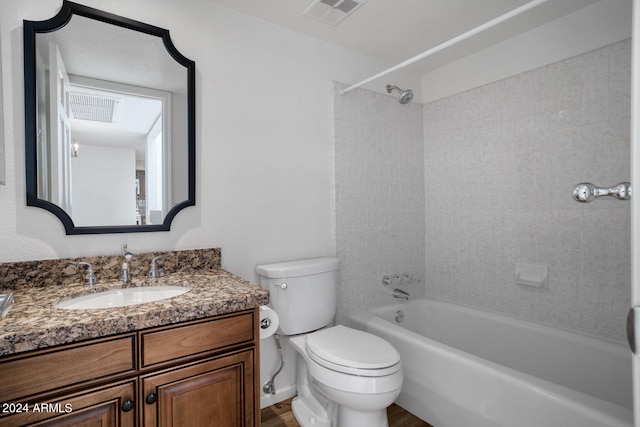 full bathroom with vanity, tiled shower / bath combo, and toilet