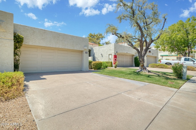 pueblo-style home featuring a garage