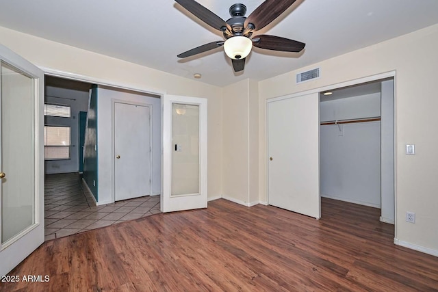 16828 W Windermere Way, Surprise, AZ 85374 - unfurnished bedroom featuring wood finished floors and ceiling fan