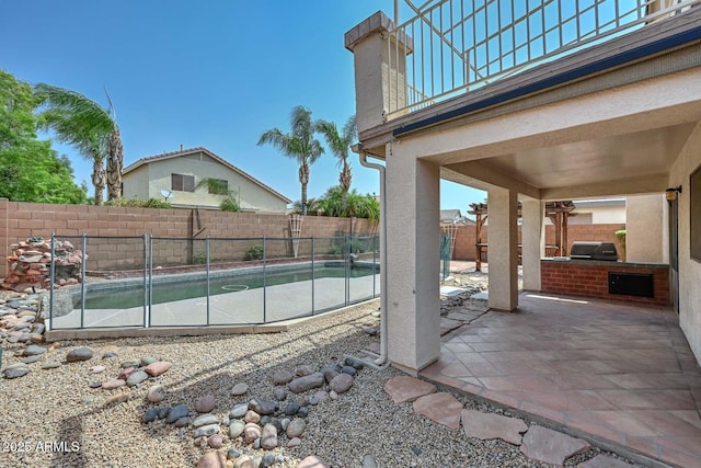 16828 W Windermere Way, Surprise, AZ 85374 - fenced backyard with an outdoor kitchen and a patio area