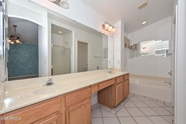 16828 W Windermere Way, Surprise, AZ 85374 - bathroom featuring double vanity, a garden tub, a stall shower, tile patterned floors, and a ceiling fan