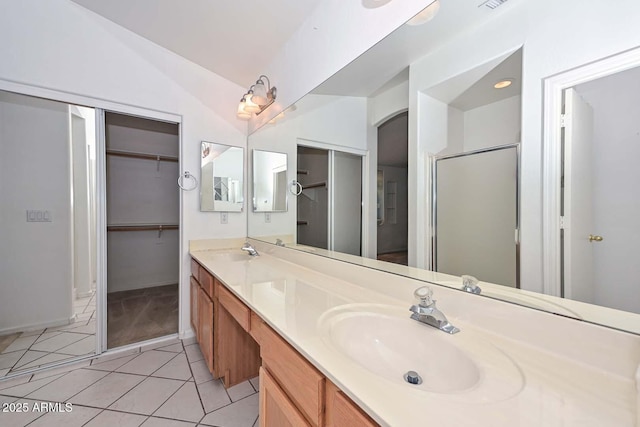 16828 W Windermere Way, Surprise, AZ 85374 - full bathroom with double vanity, tile patterned flooring, a spacious closet, and a shower with shower door