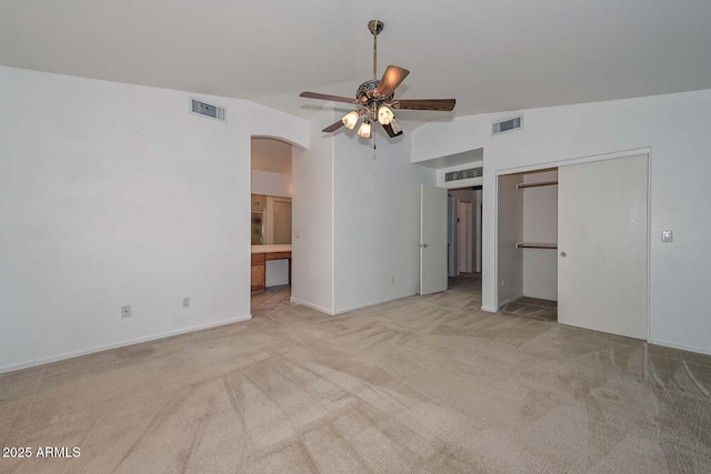 16828 W Windermere Way, Surprise, AZ 85374 - unfurnished bedroom featuring lofted ceiling, carpet, arched walkways, a closet, and ceiling fan