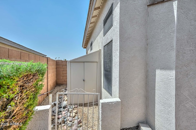 16828 W Windermere Way, Surprise, AZ 85374 - view of side of property featuring stucco siding, a fenced backyard, and a shed