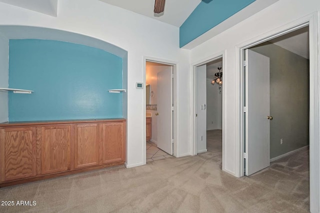 16828 W Windermere Way, Surprise, AZ 85374 - empty room featuring a ceiling fan, light colored carpet, and arched walkways