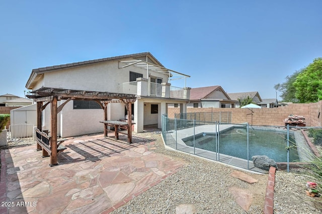 16828 W Windermere Way, Surprise, AZ 85374 - back of house with a fenced backyard, a balcony, a pergola, and stucco siding