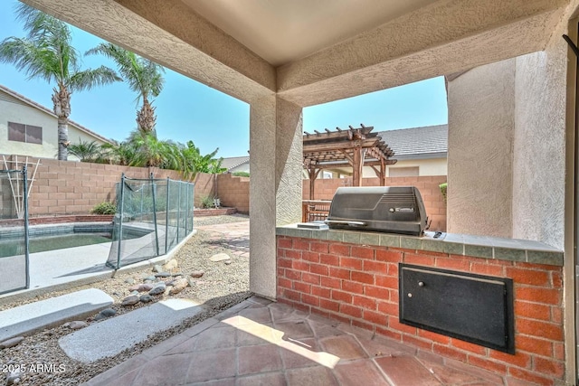 16828 W Windermere Way, Surprise, AZ 85374 - fenced backyard with an outdoor kitchen, a pergola, and a patio area