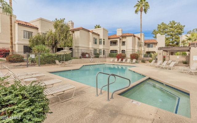 view of pool with a community hot tub, a patio, and a pergola