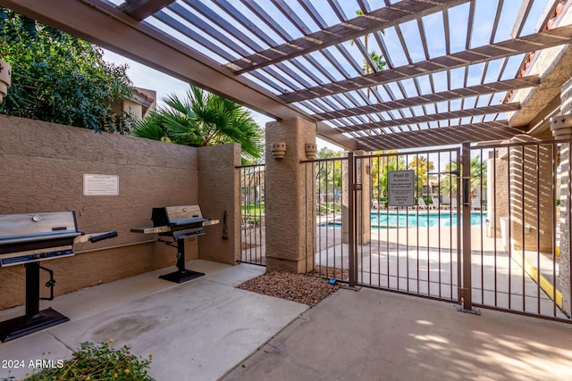 view of patio with a pergola, a community pool, and grilling area