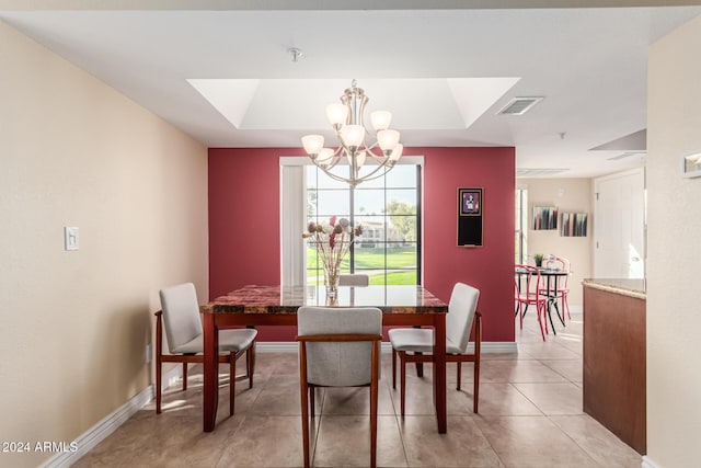 dining room with light tile patterned floors and a notable chandelier