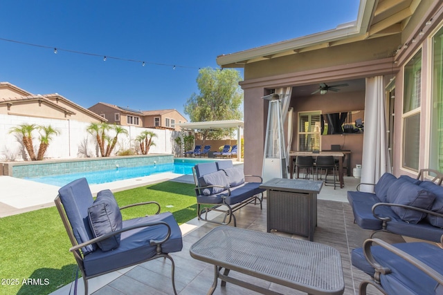 12035 S 186th Ave, Goodyear, AZ 85338 - fenced backyard featuring outdoor lounge area, a ceiling fan, and a patio area