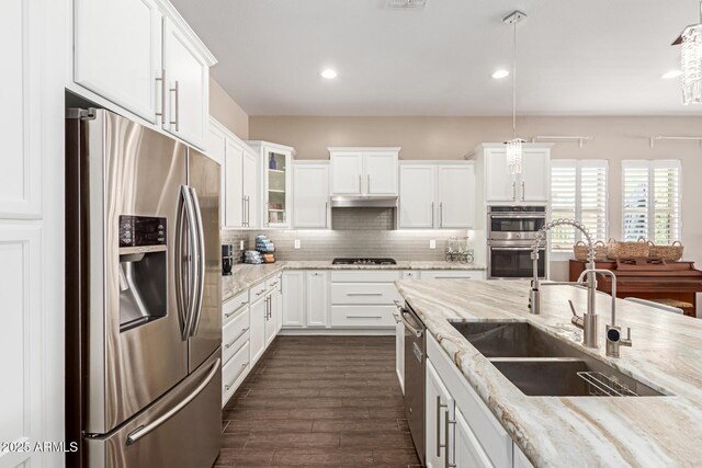 12035 S 186th Ave, Goodyear, AZ 85338 - kitchen with appliances with stainless steel finishes, a sink, white cabinetry, decorative backsplash, and recessed lighting