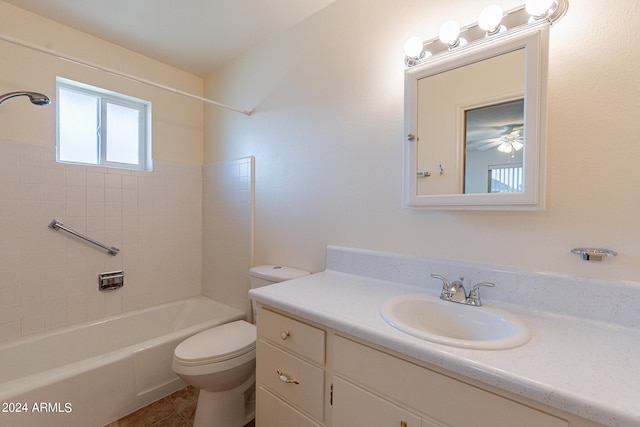 full bathroom featuring tiled shower / bath, vanity, toilet, and tile patterned floors