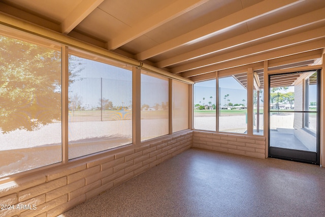 unfurnished sunroom with beam ceiling