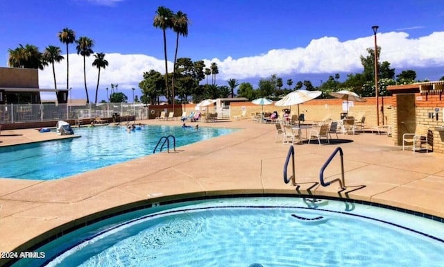 view of swimming pool with a patio