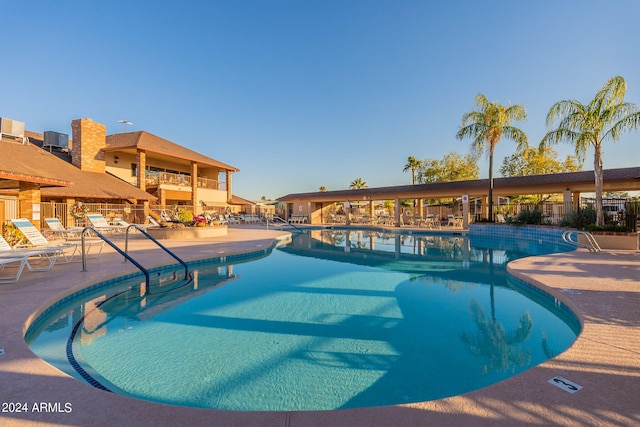 view of swimming pool with a patio area and cooling unit