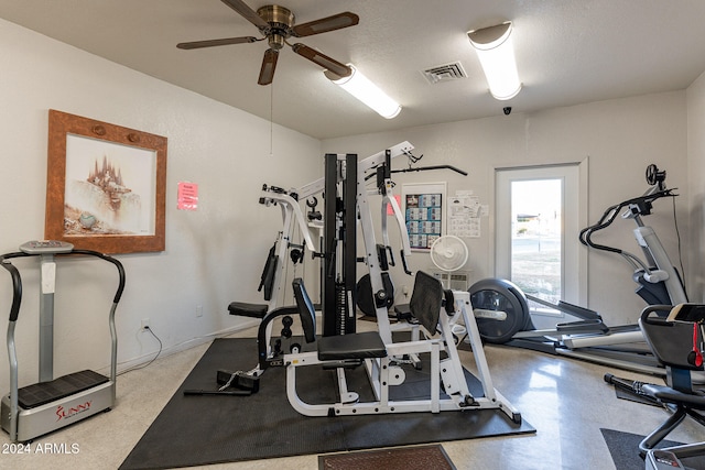 exercise area featuring a textured ceiling and ceiling fan