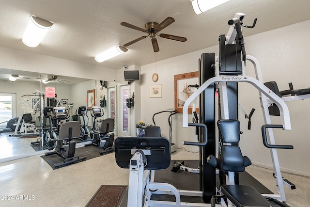 exercise room featuring a textured ceiling and ceiling fan