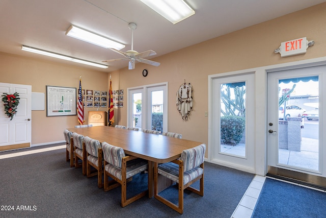 dining room featuring dark colored carpet and ceiling fan