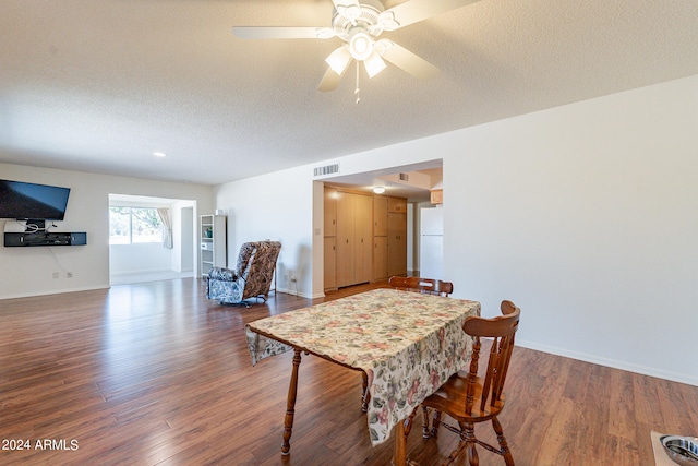 dining room featuring ceiling fan, wood-type flooring, and a textured ceiling