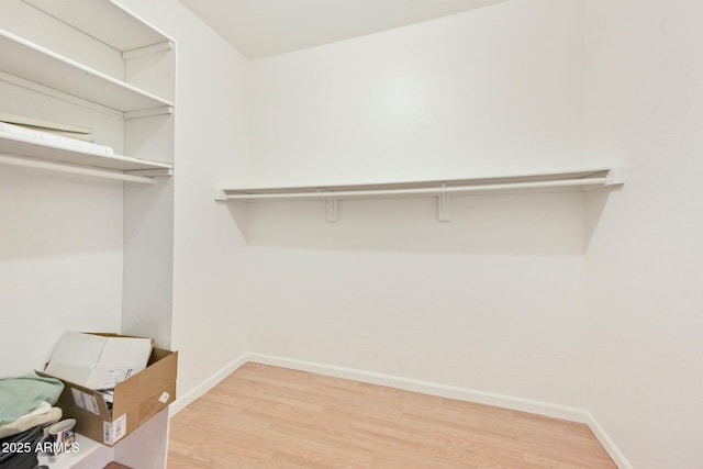 walk in closet featuring light wood-style flooring