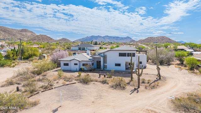 view of front of house with a mountain view, a residential view, and stucco siding
