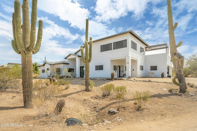 back of property featuring stucco siding