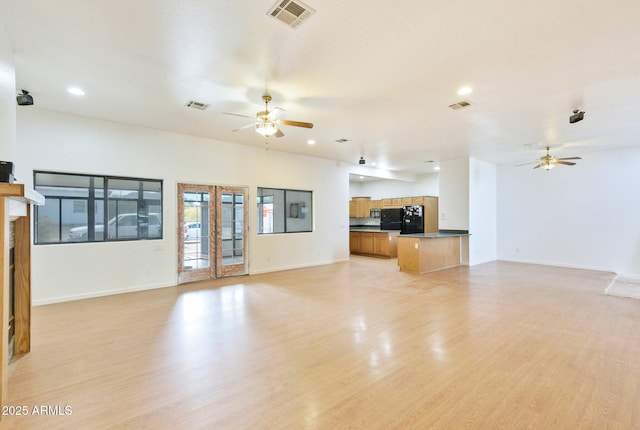 unfurnished living room featuring a ceiling fan, baseboards, and recessed lighting