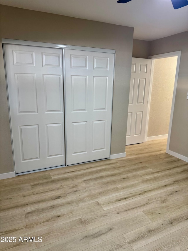 6810 N 35th Ave Unit H, Phoenix, AZ 85017 - unfurnished bedroom featuring light wood-style flooring, a closet, and baseboards